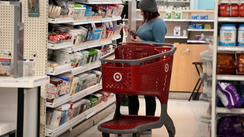 A shopper checks out an item in a Target store in Pittsburgh on Monday, Jan. 23, 2023. (AP Photo/Gene J. Puskar)