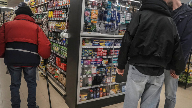 Shoppers browse pharmaceutical items locked in a glass cabinet at a Gristedes supermarket, Tuesday Jan. 31, 2023, in New York. (AP Photo/Bebeto Matthews)